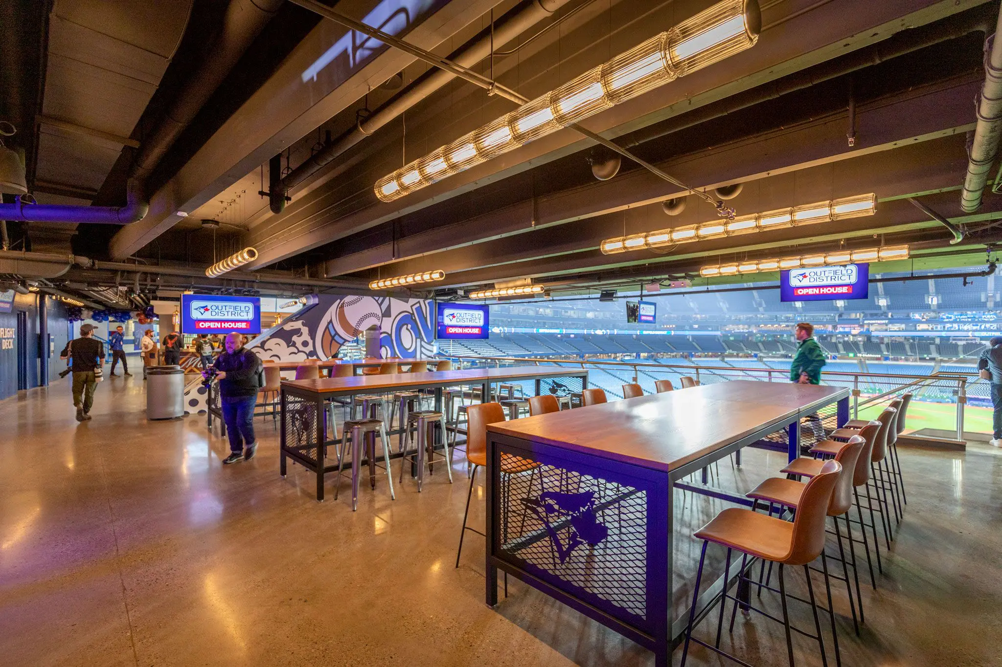 Modern bowling alley with vibrant lighting and seating areas.