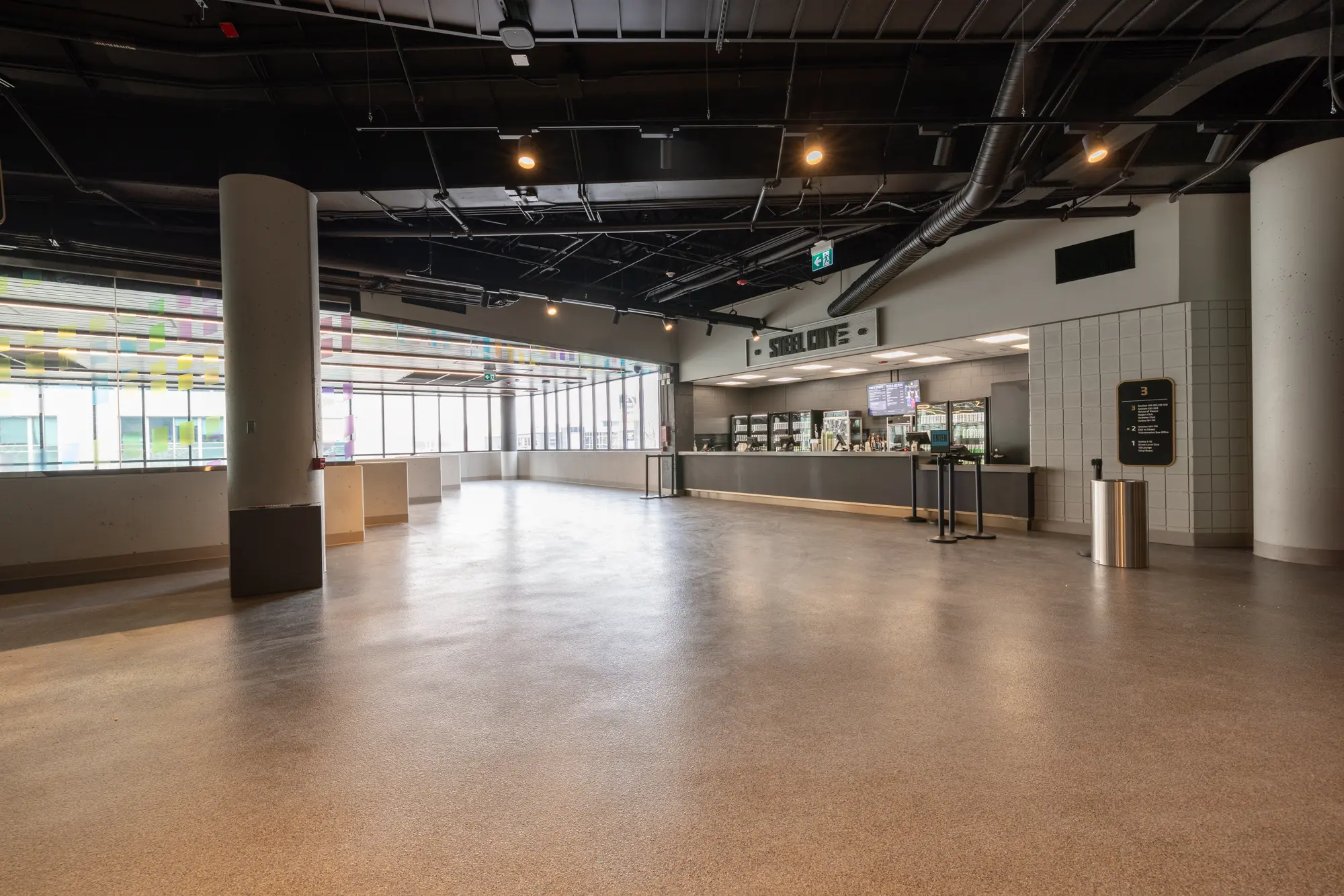 Empty modern event space with polished floors and high ceilings.