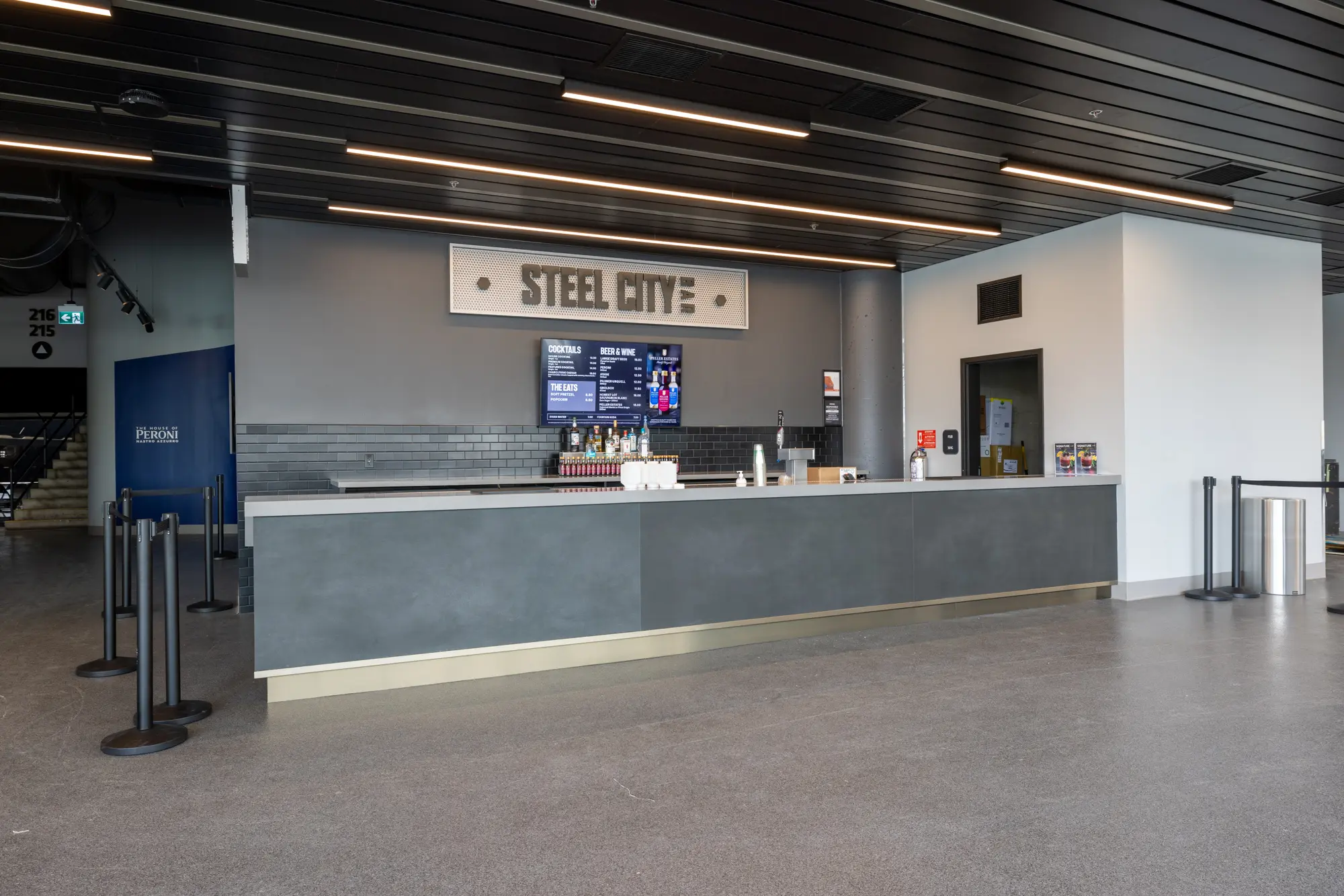 Modern cafe counter with menu screens and coffee equipment.