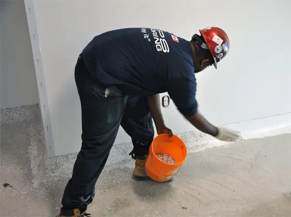 Man applying floor material