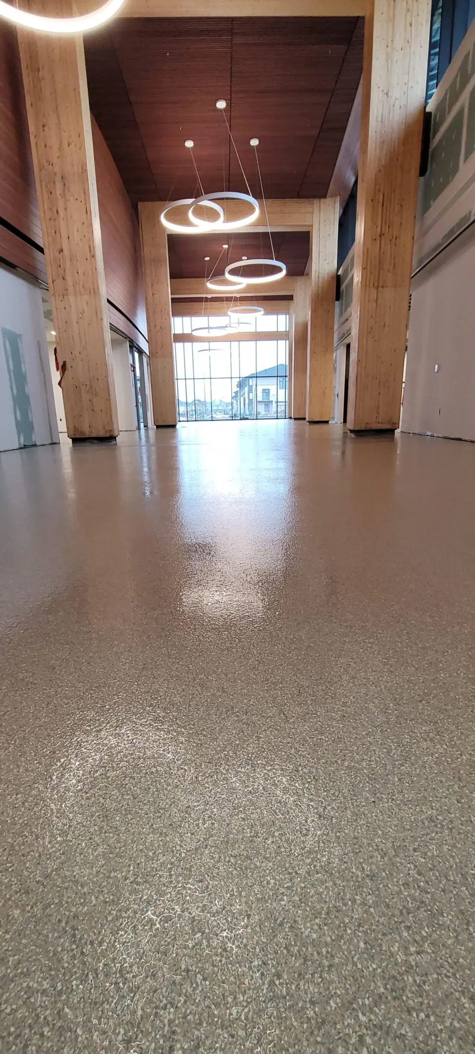 Shiny polished floor in a spacious, well-lit hallway.