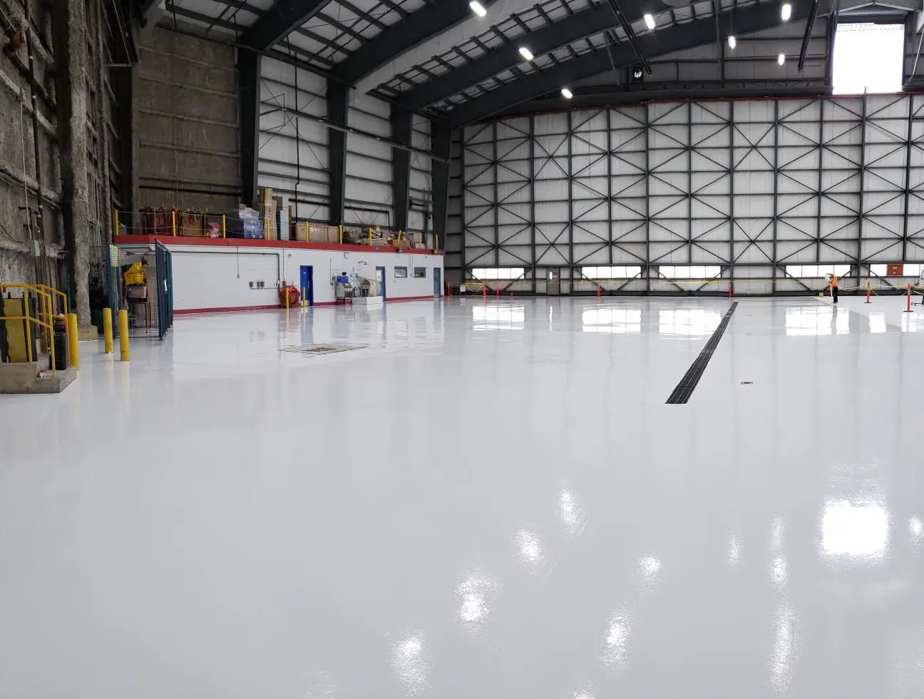 Empty indoor ice skating rink with polished ice surface.